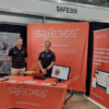 Photograph of two Safe365 team members at the Safe365 booth during an industry event