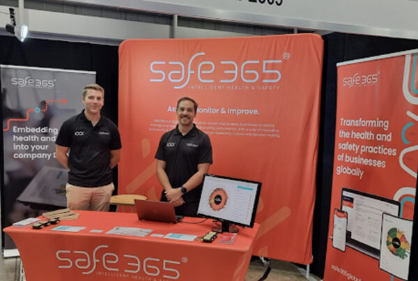 Photograph of two Safe365 team members at the Safe365 booth during an industry event