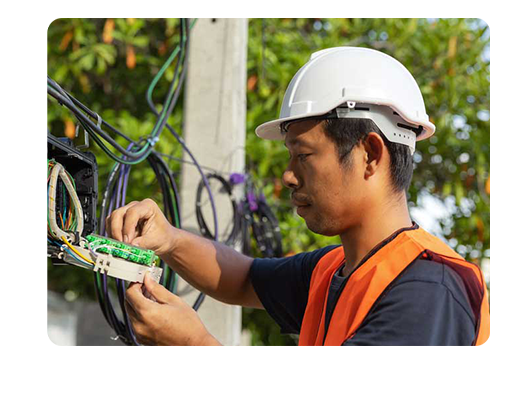 Photograph of an electrician servicing an electrical board
