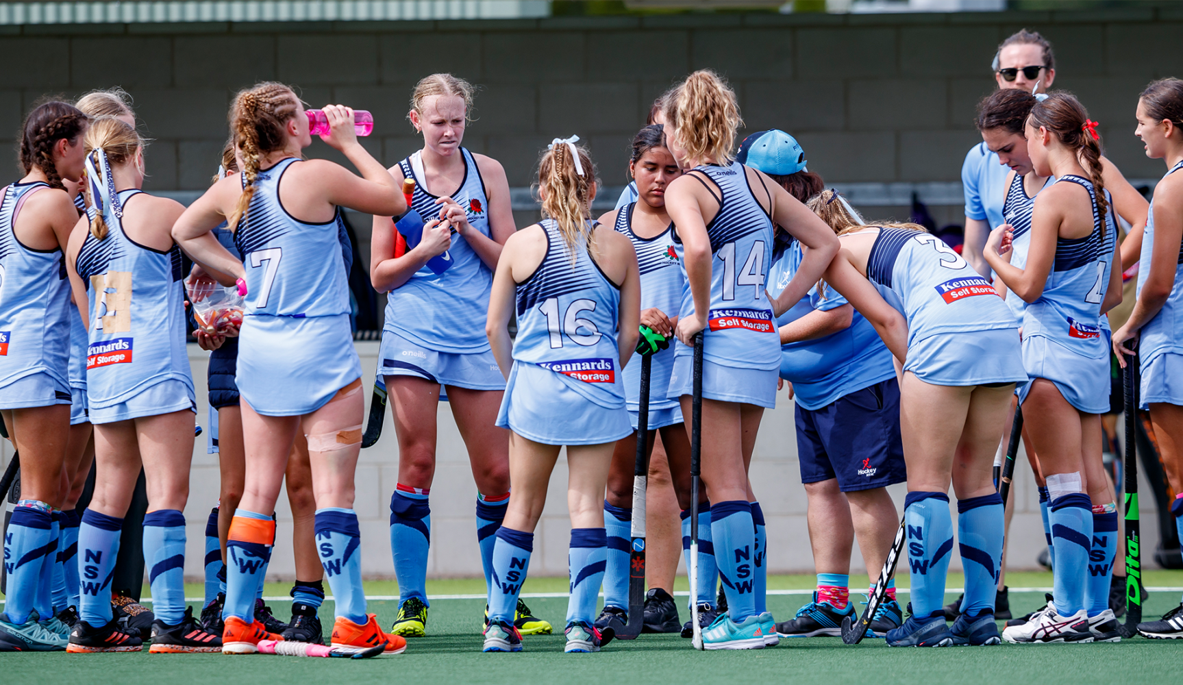 A photograph of the NSW field hockey team during a match break