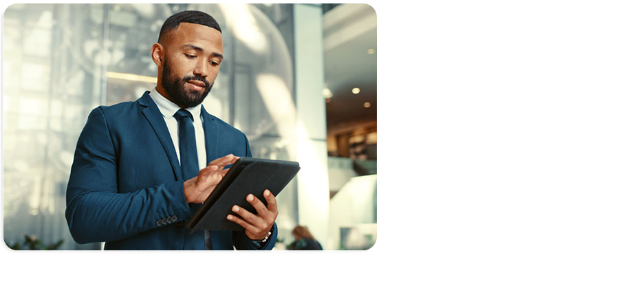 Portrait photograph of a person wearing a suit using a tablet computer